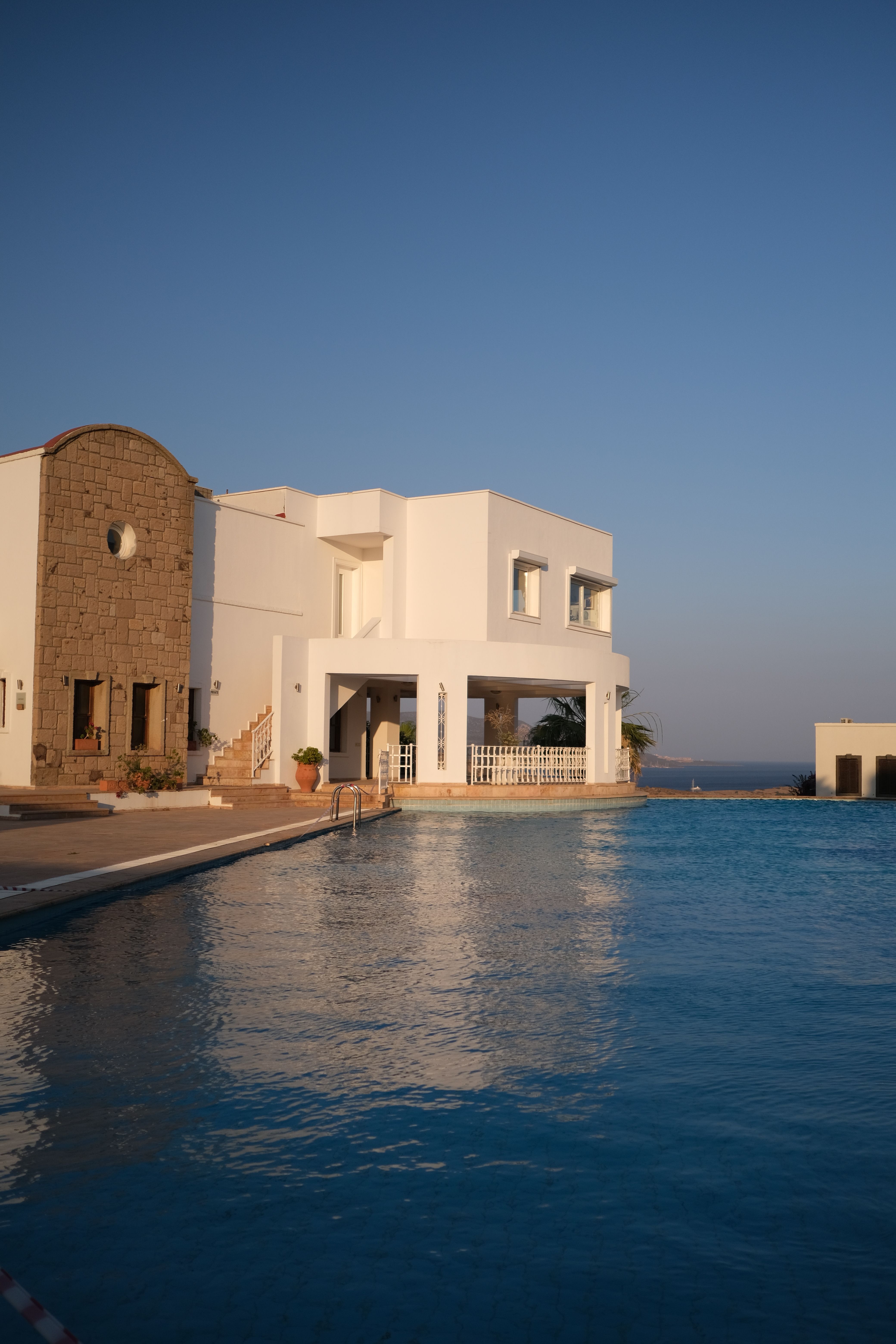 Mediterranean villa with pool and sea view at evening light